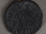 a close up of a coin with a rope around it on a table