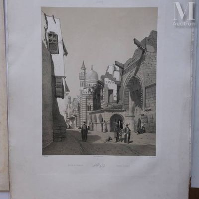 a picture of an old picture of a street in the middle of town