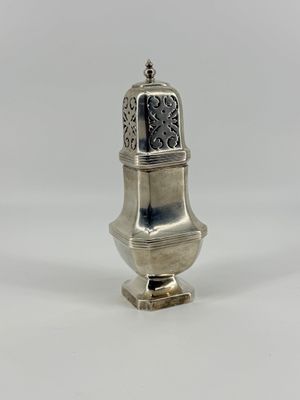 an antique silver salt shaker with a decorative design on the top
