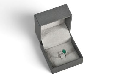 a close up of a ring in a box on a white surface