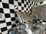 a sink in a kitchen with black and white checkered walls