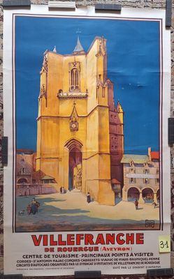 poster on the wall of a building with a building in the background
