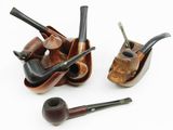 several different types of pipe holders are lined up on a white surface