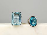 an image of a pair of rings with a blue topaz stone