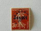 an orange stamp with a woman on it sitting on a white surface