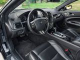 the interior of a car with black leather seats and a steering wheel