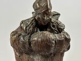 bronze statue of a woman holding a baby in her arms