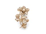 a close up of a flower broochle on a white background