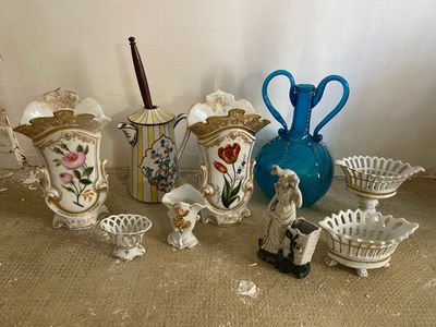 many different vases and bowls sitting on the floor