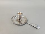a silver plate with a spoon on it on a table