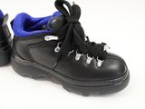 pair of black and blue shoes with laces on a white background