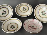 six plates with floral designs on them sitting on a table
