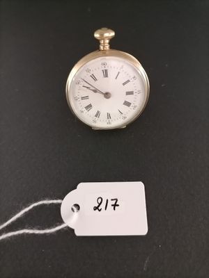 a small gold pocket watch with a price tag attached to it