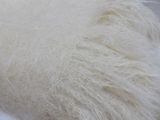 a cat that is laying down on a white blanket