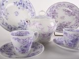 purple and white porcelain tea set with matching cups and saucers