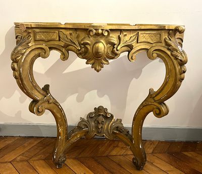 a gold table with a wooden top on a hard wood floor