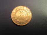 a close up of a gold coin on a black surface