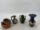 three small vases are sitting next to each other on a white surface