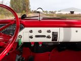 dashboard of a red and white car with a red steering wheel