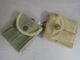 pair of small pouchs with buttons on them sitting on a table