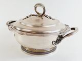 an antique silverplated casserole with a lid and handles