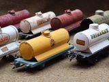 a lot of toy trains that are lined up on a table