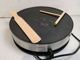 a pan with two wooden spoons sitting on top of it