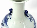 a blue and white vase sitting on a white surface