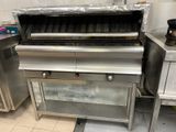 a silver stove with a grill on it in a kitchen