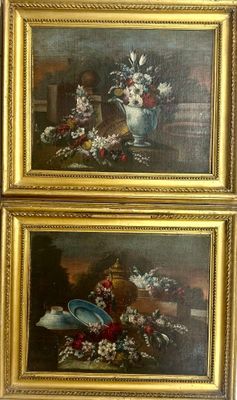 two paintings of flowers in a gold frame on a wall