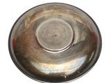 a silver bowl on a white surface with a red stripe
