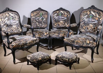 a group of chairs and a ottoman in a room