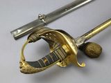 a sword with a gold handle and a ball on it