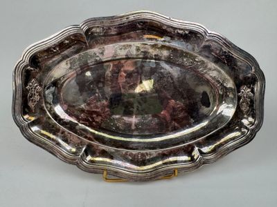 a silver tray with a gold handle on a table