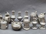 a lot of silver vases that are sitting on a table