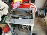 a pile of tools sitting on a cart in a garage