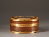 an image of a gold and brown box on a table
