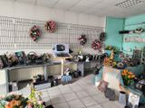 a room filled with lots of flowers and vases