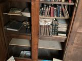 a lot of books on the floor in this room