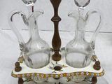 two glass vases and a candle holder on a table