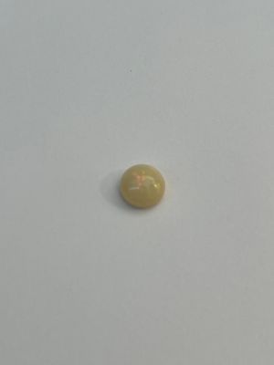 yellow opal stone on a white surface with a white background