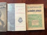 three books sitting on top of a wooden table next to each other