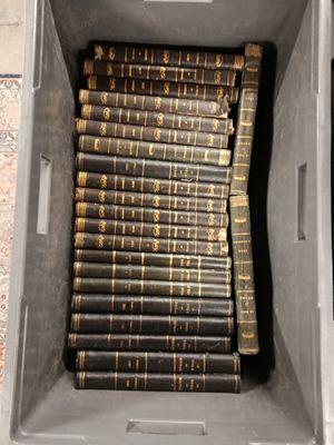 a box full of old books sitting on the floor