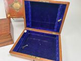 a small wooden box with a key inside of it