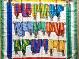 a colorful scarf hanging on a clothes line on a wooden floor