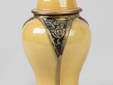 an image of a yellow vase with a lid sitting on a table