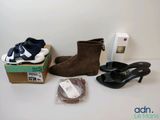 several pairs of shoes are sitting on a table next to a box of shoes
