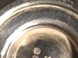 a close up of a silver plate with a picture of two people on it