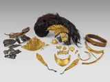 an image of a collection of gold and silver jewelry on a white surface