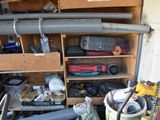 a garage filled with tools and a shelf full of tools